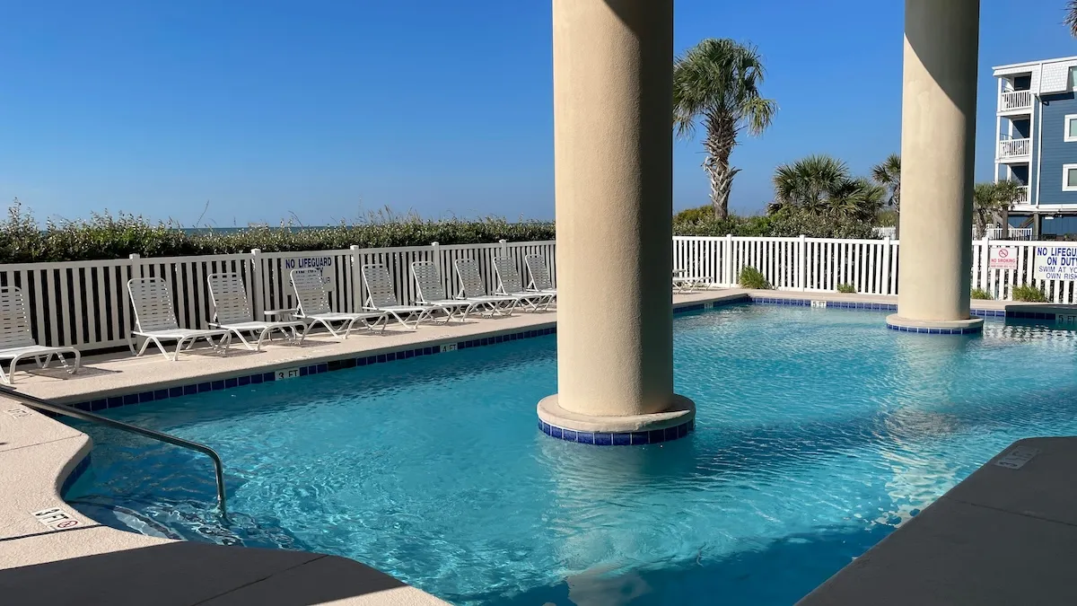 The outdoor pool is securely gated, has oceanfront views and a depth range of 3 to 5 feet.